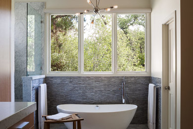 Inspiration for a mid-sized contemporary master bathroom in San Francisco with flat-panel cabinets, medium wood cabinets, marble benchtops, a freestanding tub, a corner shower, matchstick tile, beige walls, marble floors and blue tile.