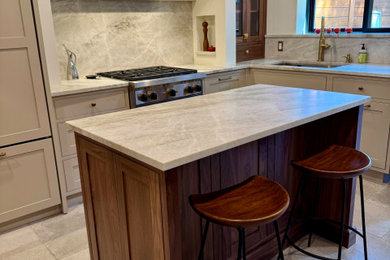 Inspiration for a mid-sized transitional u-shaped porcelain tile and gray floor eat-in kitchen remodel in New York with an undermount sink, shaker cabinets, beige cabinets, quartzite countertops, beige backsplash, stone slab backsplash, paneled appliances, an island and beige countertops