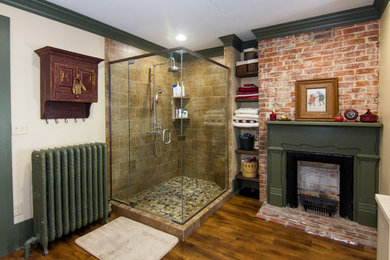 Large mountain style master medium tone wood floor bathroom photo in Other with an undermount sink, furniture-like cabinets, beige cabinets, a two-piece toilet, beige walls, solid surface countertops and a hinged shower door