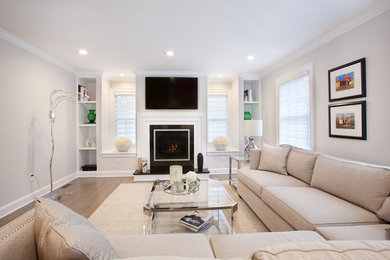 Inspiration for a mid-sized transitional open concept dark wood floor and brown floor family room remodel in New York with gray walls, a standard fireplace, a wood fireplace surround and a wall-mounted tv