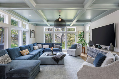 Transitional light wood floor, beige floor and coffered ceiling living room photo in Boston with white walls and a wall-mounted tv