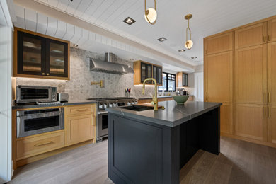 Eat-in kitchen - huge scandinavian light wood floor eat-in kitchen idea in Los Angeles with shaker cabinets, light wood cabinets, quartzite countertops, gray backsplash, ceramic backsplash, stainless steel appliances, an island, gray countertops and an undermount sink