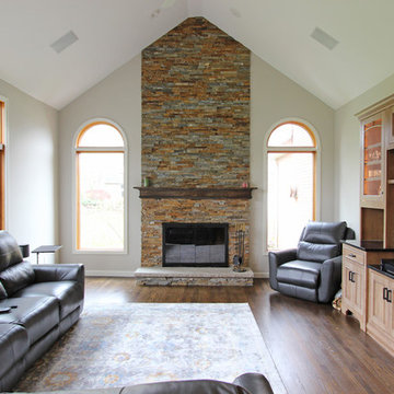 Two Toned Kitchen with White Island and Great Room Stacked Stone Fireplace