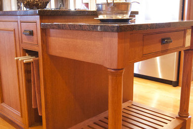 Eat-in kitchen - large traditional u-shaped light wood floor eat-in kitchen idea in Omaha with an undermount sink, beaded inset cabinets, medium tone wood cabinets, granite countertops, multicolored backsplash, ceramic backsplash, stainless steel appliances and an island