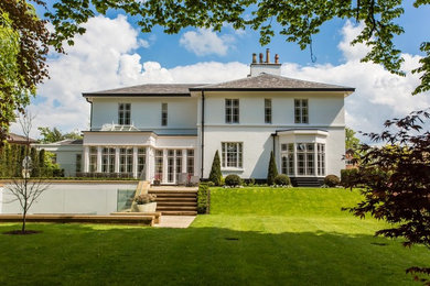 Inspiration for a beige classic two floor house exterior in London with a hip roof.