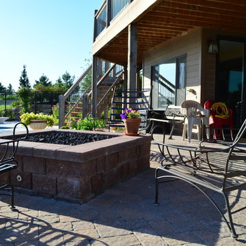 Comfortable backyard retreat with fire pit, paver patio and pool design