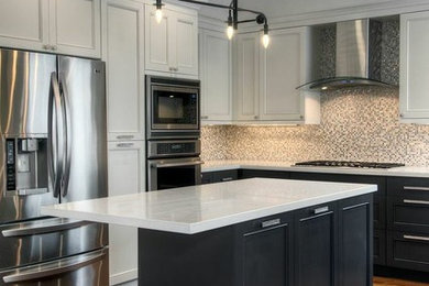 Inspiration for a mid-sized transitional u-shaped medium tone wood floor and brown floor kitchen remodel in San Francisco with beaded inset cabinets, white cabinets, quartz countertops, multicolored backsplash, glass tile backsplash, stainless steel appliances, an island and white countertops