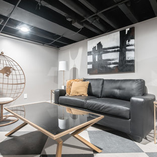 Small eclectic fully buried basement in Philadelphia with grey walls, ceramic flooring and black floors.