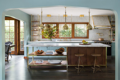 Inspiration for a transitional galley kitchen in Portland with an undermount sink, shaker cabinets, blue cabinets, marble benchtops, grey splashback, black appliances, dark hardwood floors, with island and white benchtop.