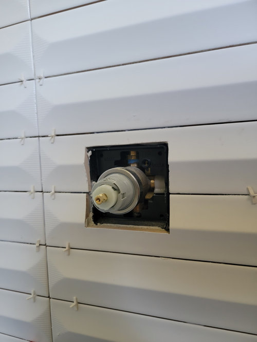 Shower escutcheon plate gap due to raised center on tiles