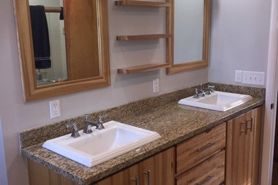 Mid-sized elegant 3/4 white tile and ceramic tile travertine floor and beige floor bathroom photo in Salt Lake City with flat-panel cabinets, light wood cabinets, gray walls, a drop-in sink and granite countertops