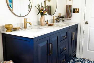 Eclectic master porcelain tile, blue floor and double-sink bathroom photo in DC Metro with recessed-panel cabinets, blue cabinets, white walls, an undermount sink, marble countertops, white countertops and a freestanding vanity
