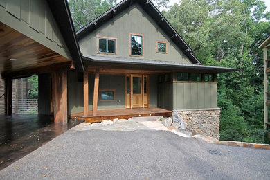 Example of a mid-sized minimalist green two-story concrete fiberboard gable roof design in Other