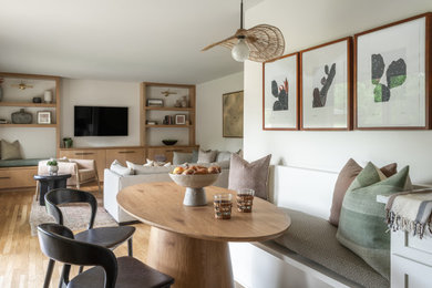 Dining room - mid-century modern medium tone wood floor dining room idea in Austin with white walls