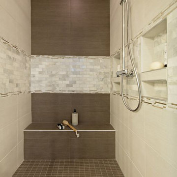 Brown and cream tile shower with Mother of Pearl accent tiles
