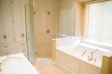 Mid-sized transitional master beige tile and subway tile limestone floor and beige floor corner shower photo in Other with beaded inset cabinets, white cabinets, an undermount tub, beige walls, an undermount sink, marble countertops and a hinged shower door