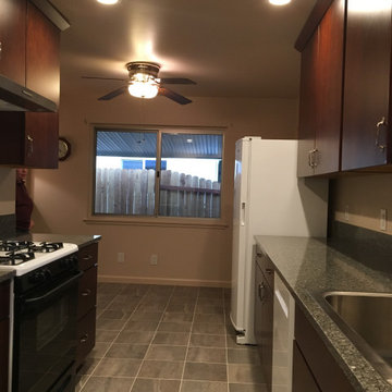 Simple green/grey tile floor coordinates w/green tone countertop.