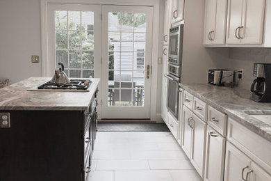 Mid-sized transitional l-shaped ceramic tile and multicolored floor eat-in kitchen photo in Boston with an undermount sink, shaker cabinets, white cabinets, quartzite countertops, gray backsplash, stone slab backsplash, stainless steel appliances, an island and multicolored countertops
