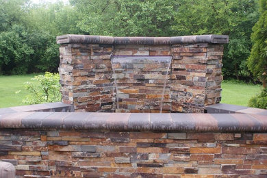 Design ideas for a large rustic full sun backyard stone landscaping in Chicago for summer.