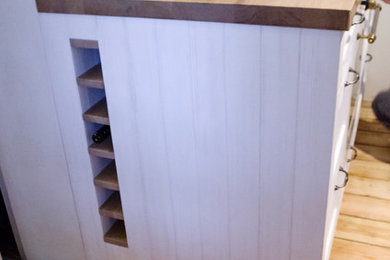 Inspiration for a small rustic single-wall kitchen remodel in Other with an integrated sink and recessed-panel cabinets