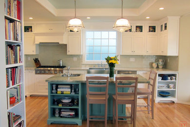 Example of a mid-sized transitional u-shaped light wood floor eat-in kitchen design in Los Angeles with a double-bowl sink, shaker cabinets, quartzite countertops, beige backsplash, ceramic backsplash, stainless steel appliances, white cabinets and an island