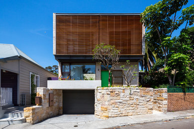 Design ideas for a mid-sized contemporary two-storey brick exterior in Sydney with a flat roof.