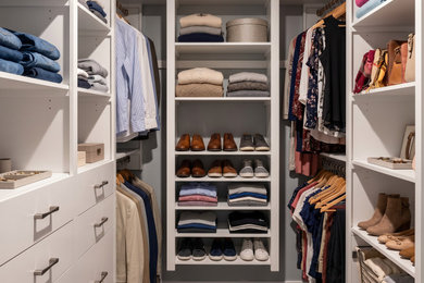 Inspiration for a mid-sized walk-in closet remodel in Philadelphia with white cabinets