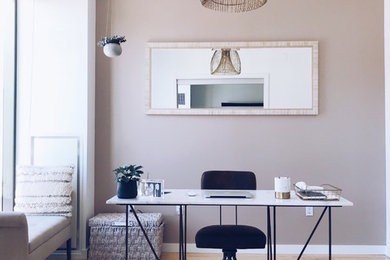 Home office - coastal freestanding desk light wood floor and brown floor home office idea in Boston with gray walls