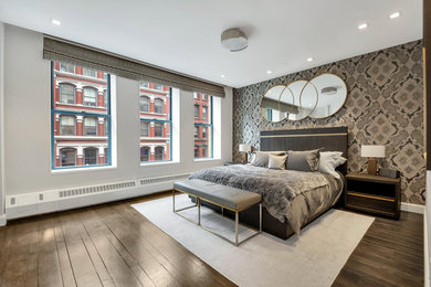 Bedroom - large transitional master dark wood floor and brown floor bedroom idea in New York with gray walls
