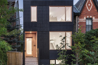 Inspiration for a mid-sized modern black three-story wood exterior home remodel in Toronto