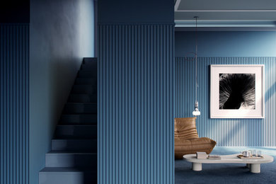 Modelo de entrada contemporánea con paredes azules, moqueta, suelo azul y panelado