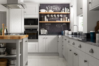 Photo of a large contemporary l-shaped separate kitchen in Other with a drop-in sink, shaker cabinets, grey cabinets, quartzite benchtops, black splashback, panelled appliances, ceramic floors, with island and grey floor.