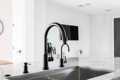 Example of a minimalist kitchen design in Los Angeles with a double-bowl sink