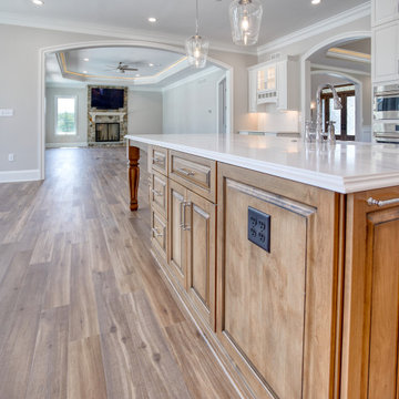 Transitional Kitchen with Two Toned Gathering Island & Archways