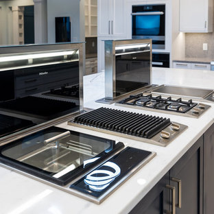 Large mediterranean kitchen pantry designs - Large tuscan u-shaped porcelain floor and white floor kitchen pantry photo in Jacksonville with flat-panel cabinets, marble countertops, gray backsplash, stone slab backsplash, stainless steel appliances, an island and white countertops