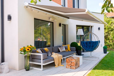 Inspiration for a mid-sized contemporary backyard deck remodel in Phoenix with an awning