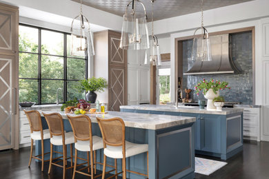 Kitchen - transitional l-shaped dark wood floor, brown floor and tray ceiling kitchen idea in Atlanta with an undermount sink, recessed-panel cabinets, white cabinets, blue backsplash, black appliances, two islands and blue countertops
