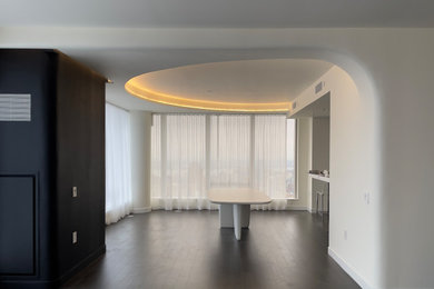 Inspiration for a mid-sized modern formal and open concept dark wood floor and brown floor living room remodel in New York with white walls, no fireplace and a media wall