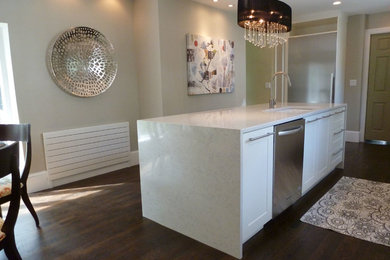 Inspiration for a contemporary l-shaped medium tone wood floor eat-in kitchen remodel in Wilmington with quartzite countertops, marble backsplash, stainless steel appliances, an island, an undermount sink, flat-panel cabinets, white cabinets, white backsplash and white countertops