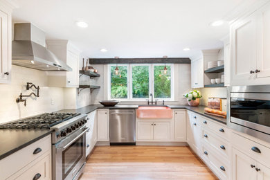 Large farmhouse u-shaped light wood floor and exposed beam eat-in kitchen photo in Boston with an undermount sink, shaker cabinets, white cabinets, quartz countertops, white backsplash, marble backsplash, stainless steel appliances, an island and gray countertops
