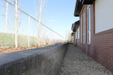 Inspiration for a mid-sized shade backyard concrete paver retaining wall landscape in Calgary for summer.