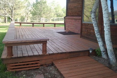 Example of a large classic side yard deck design in Denver with a pergola
