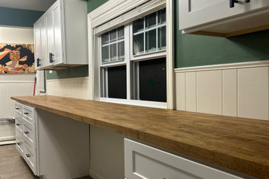 Example of a small classic kitchen design in Philadelphia with shaker cabinets, white cabinets, wood countertops and brown countertops