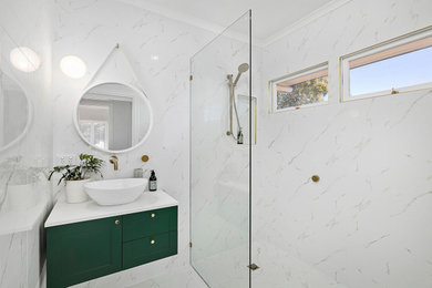 This is an example of a small traditional kids bathroom in Brisbane with recessed-panel cabinets, green cabinets, an open shower, black and white tile, ceramic tile, white walls, cement tiles, a vessel sink, engineered quartz benchtops, white floor, an open shower, white benchtops, a single vanity and a floating vanity.