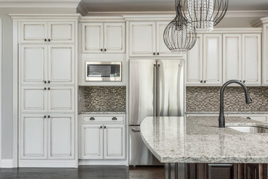 Inspiration for a large craftsman l-shaped dark wood floor open concept kitchen remodel in Indianapolis with an undermount sink, raised-panel cabinets, white cabinets, granite countertops, multicolored backsplash, mosaic tile backsplash, stainless steel appliances and an island
