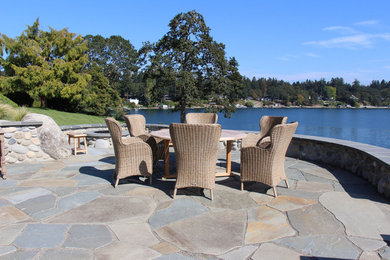 Patio kitchen - mid-sized craftsman backyard stone patio kitchen idea in Seattle with no cover