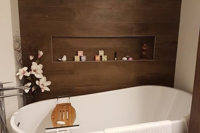 Example of a mid-sized transitional master brown tile and porcelain tile slate floor and gray floor freestanding bathtub design in Orange County with white walls, open cabinets and dark wood cabinets