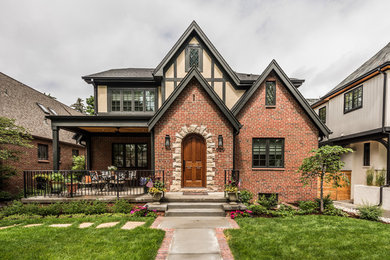 Inspiration for a mid-sized timeless red two-story stucco exterior home remodel in Denver with a shingle roof