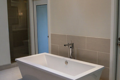 Example of a large transitional beige tile and porcelain tile porcelain tile bathroom design in Chicago with an undermount sink, shaker cabinets, dark wood cabinets, granite countertops, a one-piece toilet and beige walls