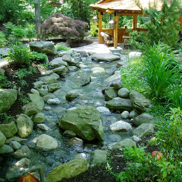 Grotto with pool house and running stream